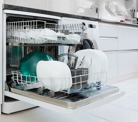Open dishwasher with plates and glasses.