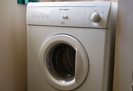 Front of a white tumble dryer or washer-dryer.