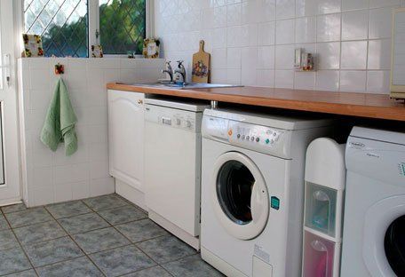Utility room with laundry appliances under a counter.